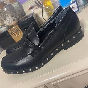 Black faux leather loafers with studded bottom and slight heel